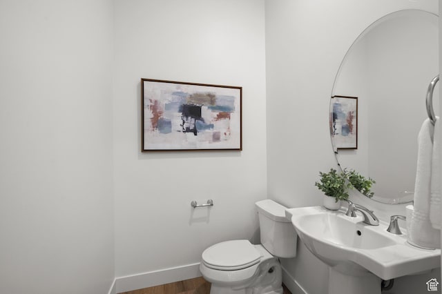 5472 N Valley View Rd W, Lehi, UT 84043 - bathroom with baseboards, wood finished floors, toilet, and a sink