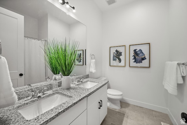 5472 N Valley View Rd W, Lehi, UT 84043 - full bathroom featuring double vanity, toilet, and baseboards