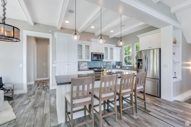 10764 S Felicity Ct, South Jordan, UT 84009 - kitchen with appliances with stainless steel finishes, beamed ceiling, light wood-style floors, decorative backsplash, and white cabinets