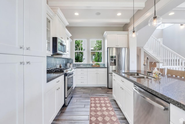 10764 S Felicity Ct, South Jordan, UT 84009 - kitchen featuring stainless steel appliances, a sink, dark wood-style flooring, dark stone countertops, and beam ceiling