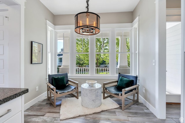 10764 S Felicity Ct, South Jordan, UT 84009 - sitting room with healthy amount of natural light, baseboards, light wood-type flooring, and a chandelier
