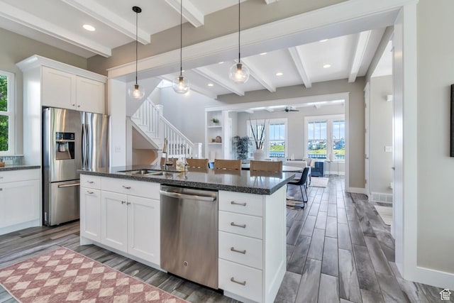 10764 S Felicity Ct, South Jordan, UT 84009 - kitchen featuring stainless steel appliances, beamed ceiling, open floor plan, a ceiling fan, and wood finished floors