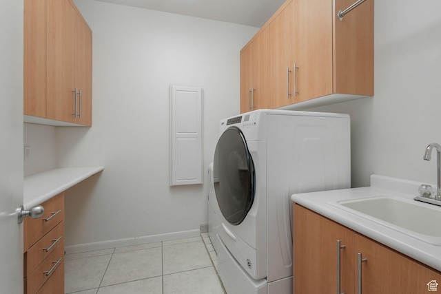4554 W Birdie Way S, Jordan, UT 84009 - washroom featuring washer / clothes dryer, cabinet space, light tile patterned floors, and baseboards