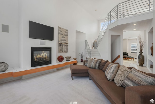 4554 W Birdie Way S, Jordan, UT 84009 - living room featuring a high ceiling, stairway, and a glass covered fireplace