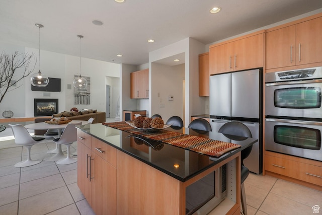 4554 W Birdie Way S, Jordan, UT 84009 - kitchen featuring appliances with stainless steel finishes, a center island, light tile patterned floors, recessed lighting, and decorative light fixtures