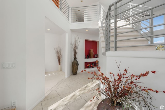 4554 W Birdie Way S, Jordan, UT 84009 - staircase featuring a towering ceiling and tile patterned flooring