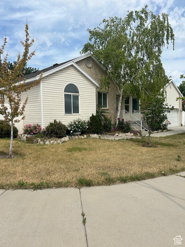 3086 S Fernbush Dr, Magna, UT 84044 - view of front facade with a front yard and brick siding
