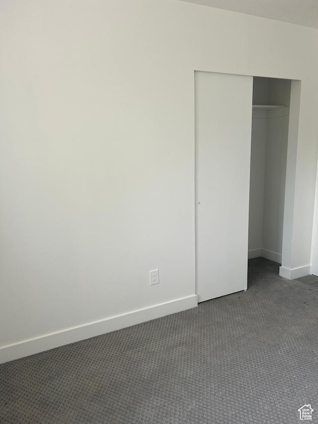 3086 S Fernbush Dr, Magna, UT 84044 - unfurnished bedroom with dark colored carpet, baseboards, and a closet