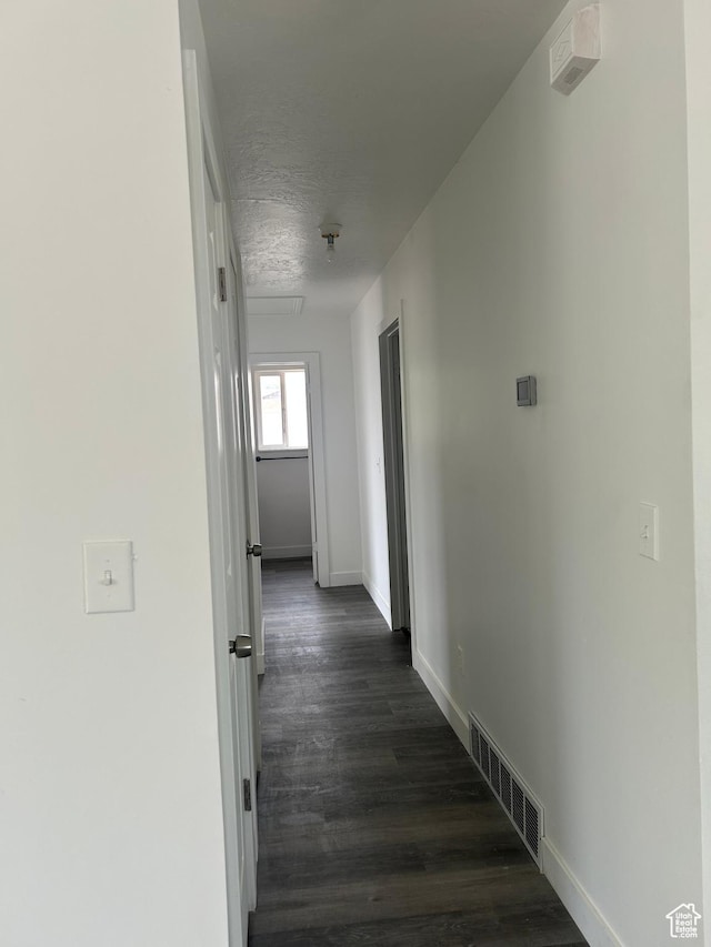 3086 S Fernbush Dr, Magna, UT 84044 - hallway featuring baseboards, dark wood finished floors, and a textured ceiling