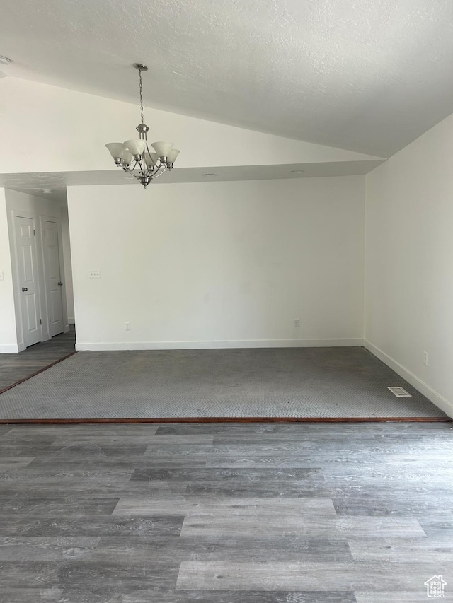 3086 S Fernbush Dr, Magna, UT 84044 - unfurnished room featuring lofted ceiling, a chandelier, baseboards, and wood finished floors