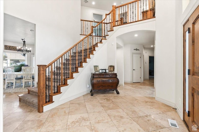 521 W Western Dr S, Kaysville, UT 84037 - foyer featuring a high ceiling, stairs, arched walkways, a chandelier, and baseboards