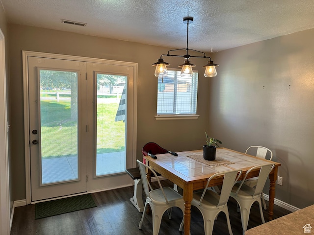 750 S 400 E Unit 38, Brigham City, UT 84302 - dining area featuring dark wood finished floors, a textured ceiling, and baseboards