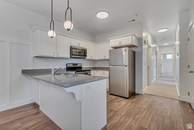 3919 W 1530 N Unit 202, Lehi, UT 84043 - kitchen featuring appliances with stainless steel finishes, a sink, a peninsula, and white cabinetry