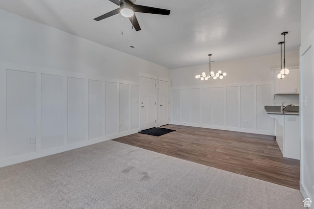 3919 W 1530 N Unit 202, Lehi, UT 84043 - carpeted empty room featuring a decorative wall, a ceiling fan, a chandelier, wood finished floors, and a sink