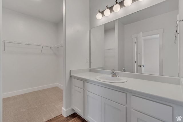 3919 W 1530 N Unit 202, Lehi, UT 84043 - bathroom with vanity, baseboards, and a walk in closet