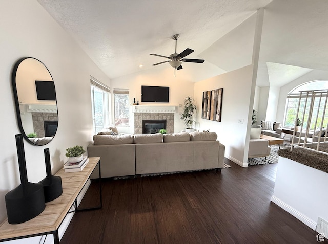 206 E Handcart Way, Sandy, UT 84070 - living area with a tiled fireplace, dark wood-type flooring, ceiling fan, vaulted ceiling, and baseboards