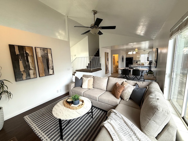 206 E Handcart Way, Sandy, UT 84070 - living room with lofted ceiling, stairs, wood finished floors, ceiling fan, and a chandelier