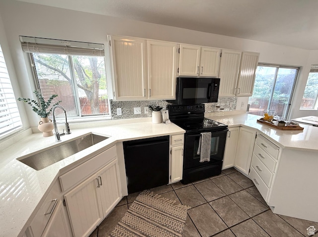 206 E Handcart Way, Sandy, UT 84070 - kitchen with black appliances, a sink, a peninsula, light countertops, and white cabinets