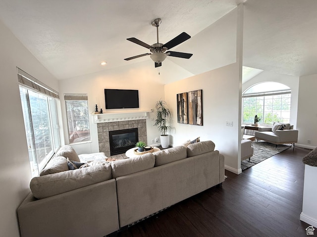 206 E Handcart Way, Sandy, UT 84070 - living area featuring lofted ceiling, a tiled fireplace, baseboards, dark wood-style floors, and ceiling fan