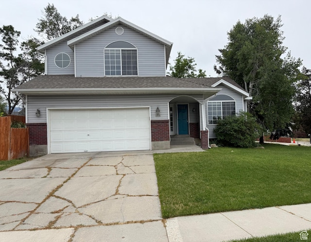 206 E Handcart Way, Sandy, UT 84070 - traditional-style house featuring an attached garage, concrete driveway, and brick siding