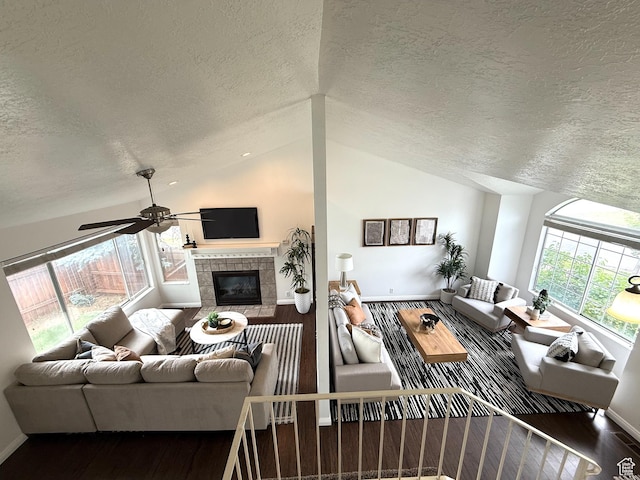 206 E Handcart Way, Sandy, UT 84070 - living area featuring wood finished floors, a textured ceiling, a fireplace, a ceiling fan, and baseboards