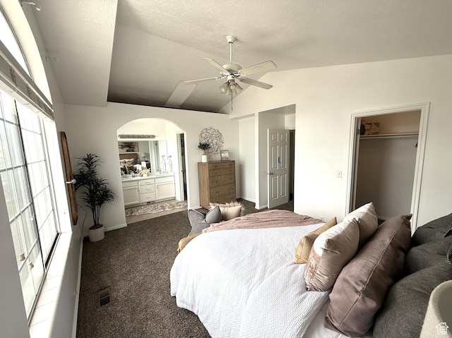 206 E Handcart Way, Sandy, UT 84070 - bedroom featuring arched walkways, vaulted ceiling, carpet flooring, ensuite bathroom, and ceiling fan
