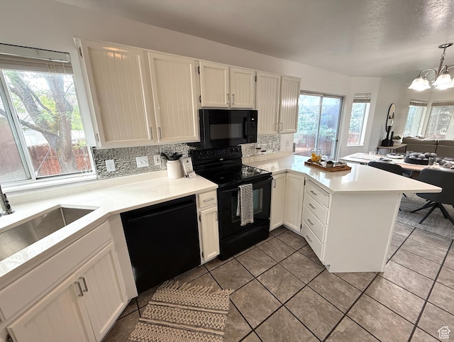 206 E Handcart Way, Sandy, UT 84070 - kitchen with black appliances, a peninsula, white cabinetry, and light countertops