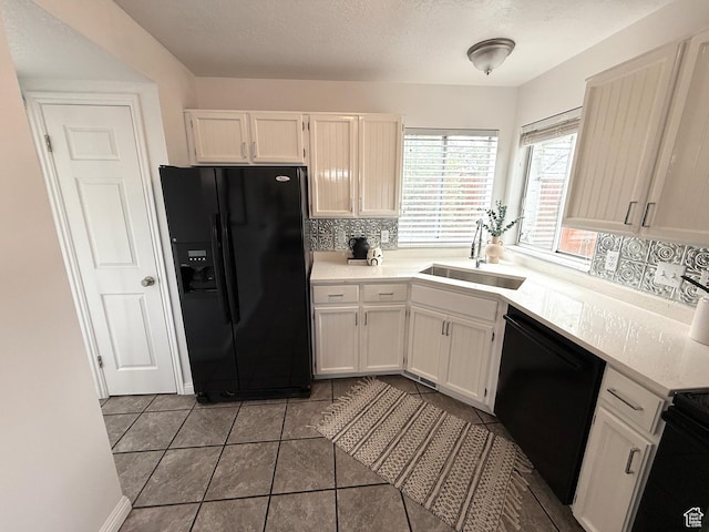 206 E Handcart Way, Sandy, UT 84070 - kitchen with black appliances, a sink, light countertops, and white cabinetry