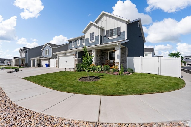 3456 S Linden Way, Syracuse, UT 84075 - view of front facade featuring board and batten siding, driveway, a porch, stone siding, and a residential view
