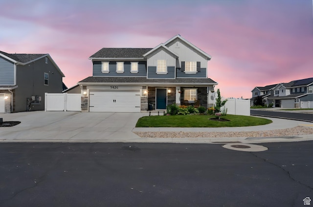 3456 S Linden Way, Syracuse, UT 84075 - view of front facade featuring concrete driveway, an attached garage, a gate, and stone siding