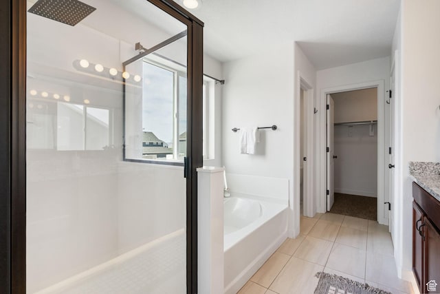 3456 S Linden Way, Syracuse, UT 84075 - bathroom with a shower stall, vanity, a bath, a spacious closet, and tile patterned floors