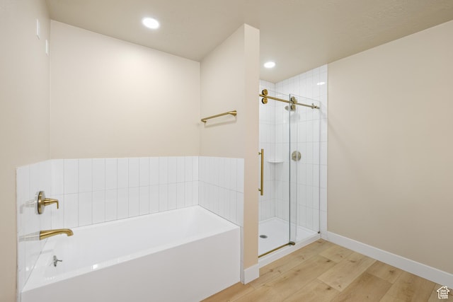 10861 N Panorama Dr, Highland, UT 84003 - full bath featuring a garden tub, wood finished floors, a shower stall, recessed lighting, and baseboards