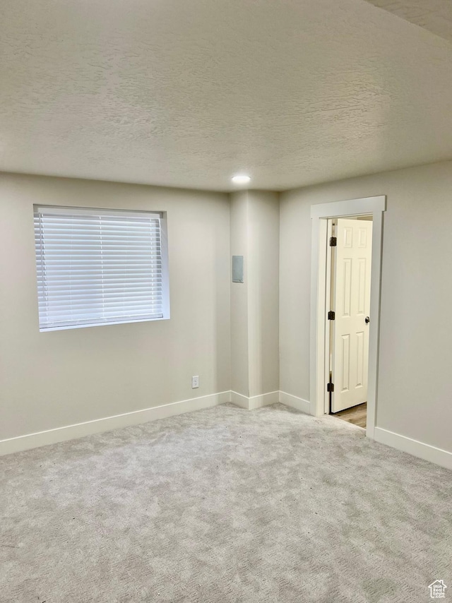 10861 N Panorama Dr, Highland, UT 84003 - spare room with baseboards, carpet, and a textured ceiling