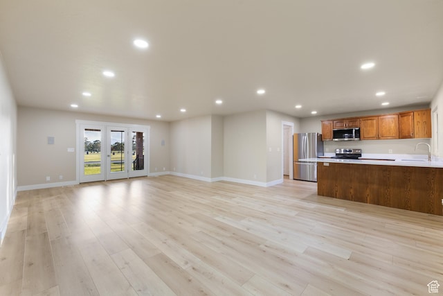 10861 N Panorama Dr, Highland, UT 84003 - kitchen featuring stainless steel appliances, recessed lighting, light countertops, open floor plan, and a sink