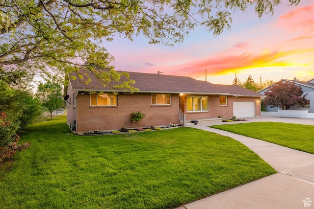 10861 N Panorama Dr, Highland, UT 84003 - ranch-style house with brick siding, a yard, a garage, concrete driveway, and roof with shingles