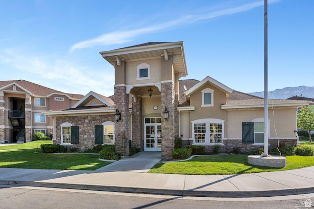 1292 W Dallin Dr N, Pleasant Grove, UT 84062 - view of front of home featuring stucco siding, stone siding, a front lawn, and french doors