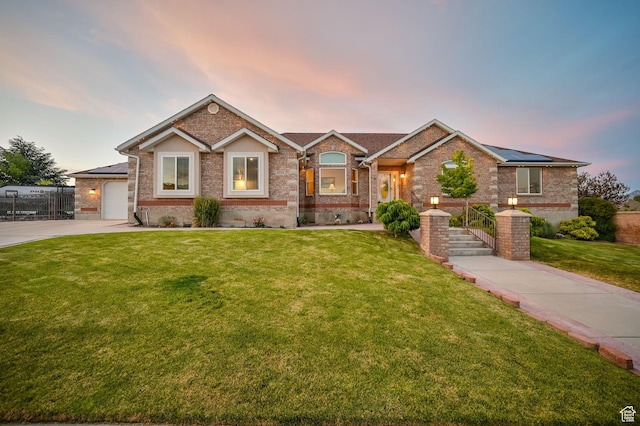 4234 W Swensen Farm Dr S, Riverton, UT 84096 - view of front of house with a yard, brick siding, and solar panels