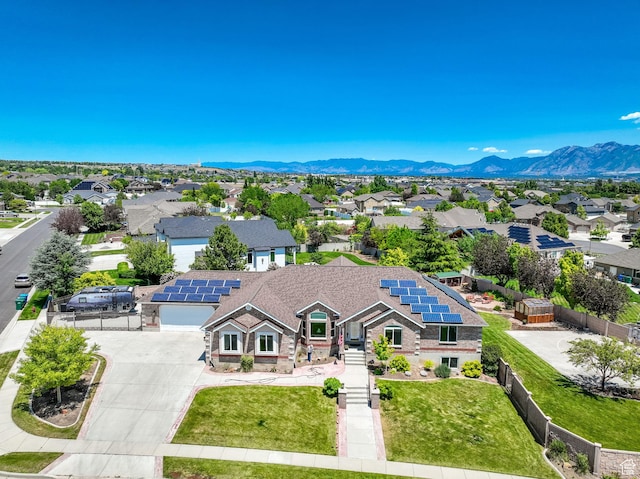 4234 W Swensen Farm Dr S, Riverton, UT 84096 - view of front of home with driveway, a residential view, roof mounted solar panels, a mountain view, and an attached garage