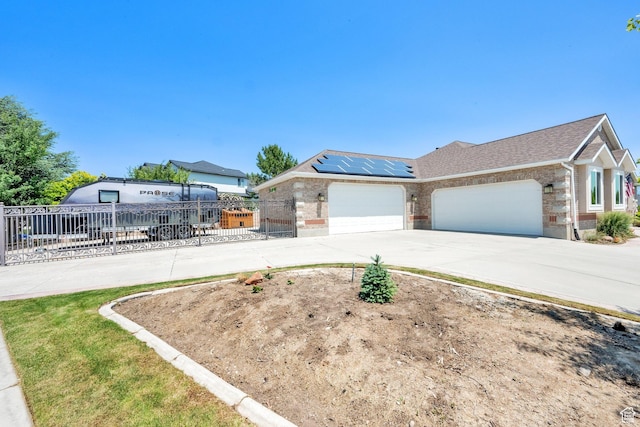 4234 W Swensen Farm Dr S, Riverton, UT 84096 - view of front facade with brick siding, an attached garage, roof mounted solar panels, and concrete driveway