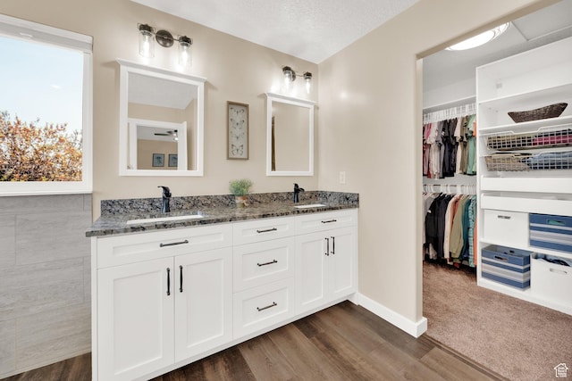 4234 W Swensen Farm Dr S, Riverton, UT 84096 - full bath with double vanity, wood finished floors, a walk in closet, and baseboards