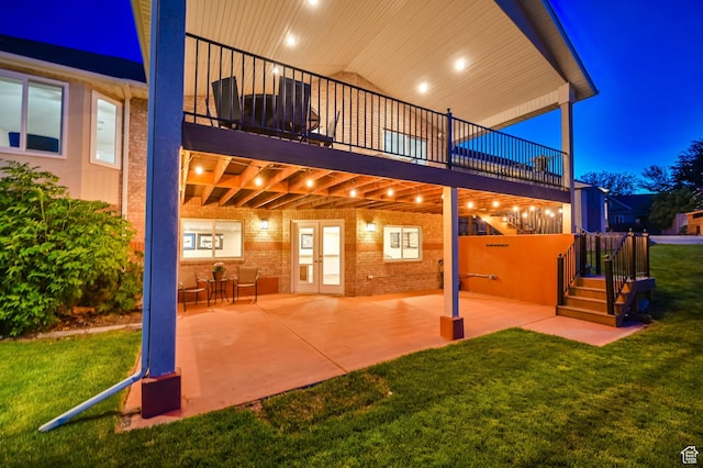 4234 W Swensen Farm Dr S, Riverton, UT 84096 - patio at night with a lawn, a patio area, and french doors