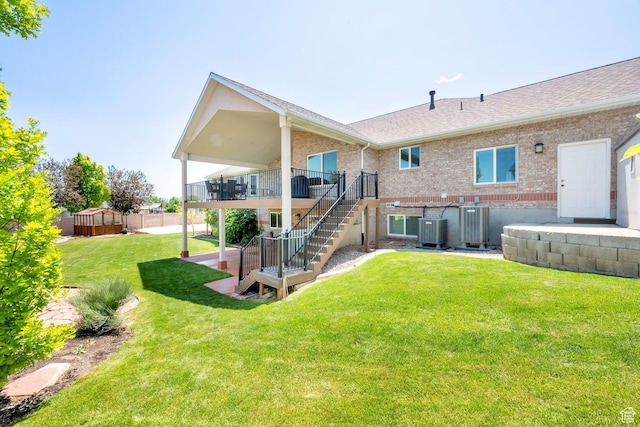 4234 W Swensen Farm Dr S, Riverton, UT 84096 - back of house with stairs, central AC, brick siding, and roof with shingles