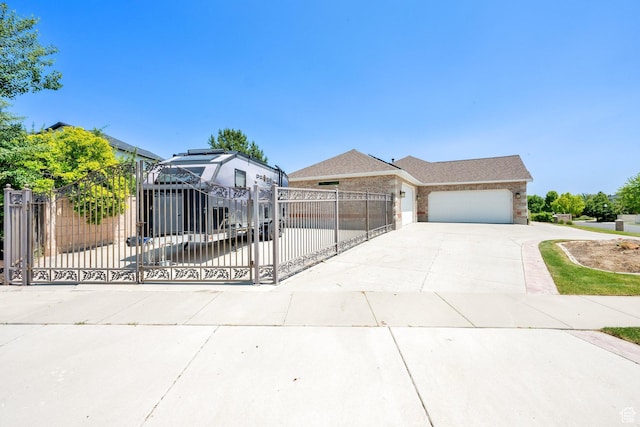 4234 W Swensen Farm Dr S, Riverton, UT 84096 - view of front of home featuring driveway, a fenced front yard, a garage, and a gate