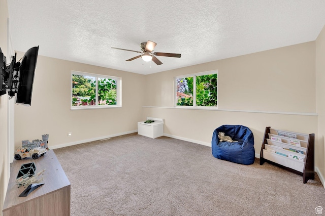 4234 W Swensen Farm Dr S, Riverton, UT 84096 - living area featuring ceiling fan, healthy amount of natural light, baseboards, carpet, and a textured ceiling