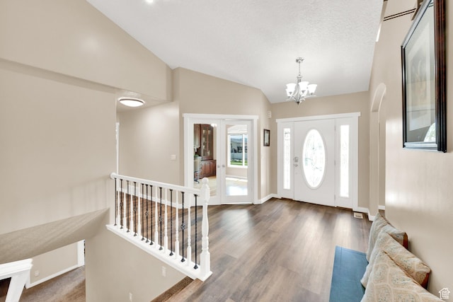 4234 W Swensen Farm Dr S, Riverton, UT 84096 - entryway featuring vaulted ceiling, a chandelier, dark wood finished floors, and baseboards