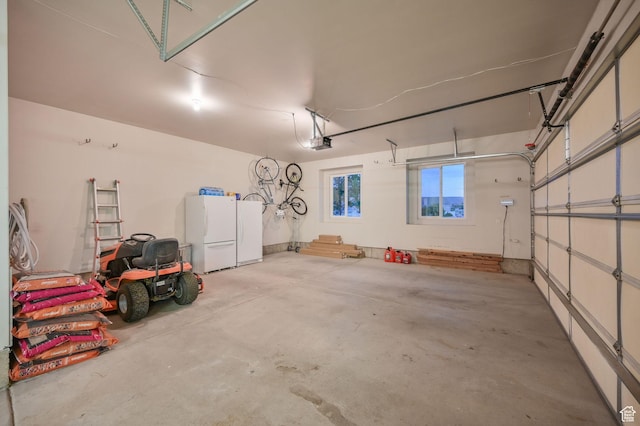 4234 W Swensen Farm Dr S, Riverton, UT 84096 - garage with freestanding refrigerator, refrigerator, and a garage door opener