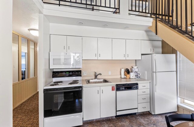 2176 S Bear Blvd Unit 404, Garden City, UT 84028 - kitchen featuring white appliances, a sink, light countertops, and white cabinets