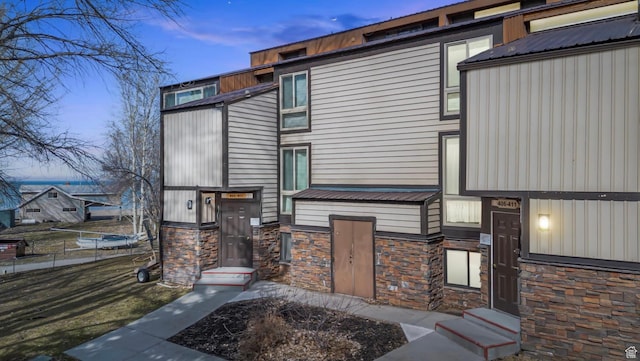 2176 S Bear Blvd Unit 404, Garden City, UT 84028 - back of property at dusk featuring stone siding and entry steps