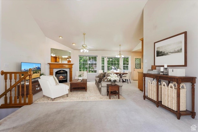 5645 S 3600 W, Roy, UT 84067 - living area featuring light carpet, a ceiling fan, a glass covered fireplace, high vaulted ceiling, and a chandelier