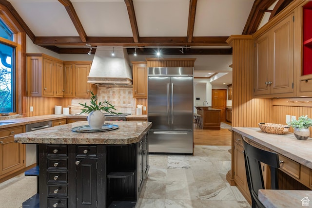 1358 E Tomahawk Dr N, Salt Lake City, UT 84103 - kitchen with built in fridge, wall chimney range hood, light countertops, decorative backsplash, and dark cabinetry